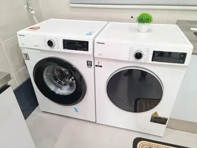 a white washer and dryer in a room at White Sweet Homestay, Kulim Hi-Tech Park Kedah in Kulim