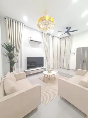a living room with two white couches and a tv at White Sweet Homestay, Kulim Hi-Tech Park Kedah in Kulim