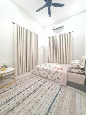 a bedroom with a bed and a ceiling fan at White Sweet Homestay, Kulim Hi-Tech Park Kedah in Kulim