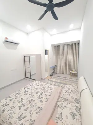 a bedroom with a bed and a ceiling fan at White Sweet Homestay, Kulim Hi-Tech Park Kedah in Kulim
