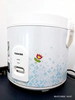 a toaster sitting on top of a black counter at HOMESTAY NAFISAH in Tapah Road