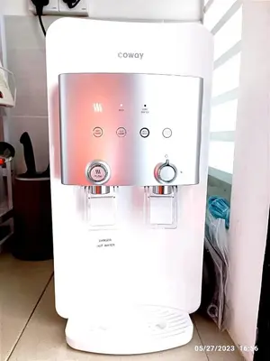 a white coffee machine sitting on the floor at HOMESTAY NAFISAH in Tapah Road