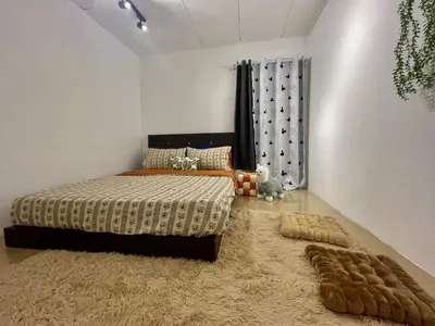 a bedroom with a bed and a large rug at Home39#4pax#jpnstyle#netflix#NearIconCity in Bukit Mertajam