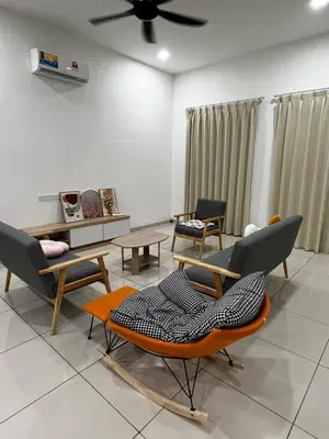 a living room with chairs and a ceiling fan at HeyFam Homestay in Sekincan
