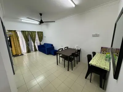 a living room with a table and chairs and a blue couch at Homestay Cikgu Iqa (Muslim) in Kuala Kangsar