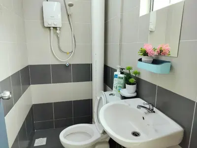 a bathroom with a white toilet and a sink at Emerald Avenue Brinchang 8 guests 3 bedrooms in Brinchang