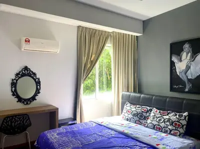 a bedroom with a bed and a window at Shamrock Breeze Villa: Coastal Haven for 29 Guests in Batu Ferringhi