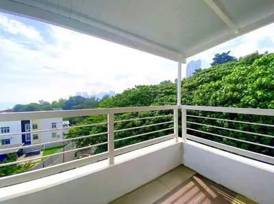 a balcony with a view of a building at Shamrock Breeze Villa: Coastal Haven for 29 Guests in Batu Ferringhi