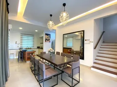 a dining room with a table and chairs at Shamrock Breeze Villa: Coastal Haven for 29 Guests in Batu Ferringhi