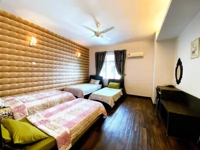 a hotel room with two beds and a window at Shamrock Breeze Villa 2: Coastal Haven for 25 Guests in Batu Ferringhi