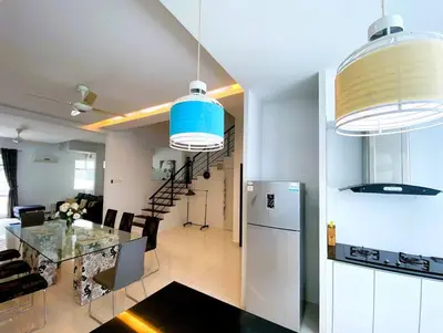 a kitchen and dining room with a table and refrigerator at Shamrock Breeze Villa 2: Coastal Haven for 25 Guests in Batu Ferringhi