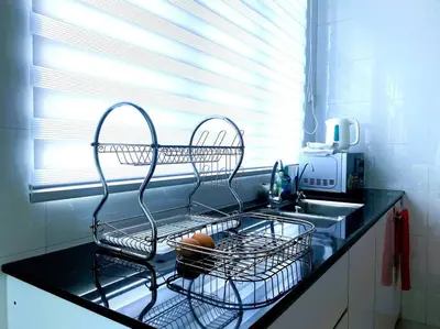 a kitchen counter with a dish drying rack next to a sink at Shamrock Breeze Villa 2: Coastal Haven for 25 Guests in Batu Ferringhi