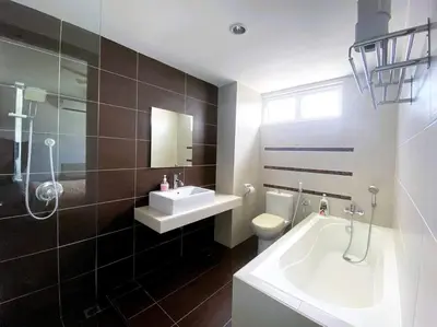 a bathroom with a sink and a toilet and a tub at Shamrock Breeze Villa 2: Coastal Haven for 25 Guests in Batu Ferringhi