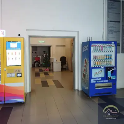 an office lobby with a christmas tree and a soda machine at Minimalist Duplex @ BayanLepas in Bayan Lepas