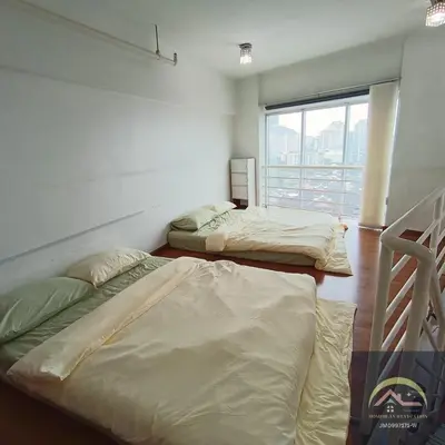 two beds in a room with a window at Minimalist Duplex @ BayanLepas in Bayan Lepas