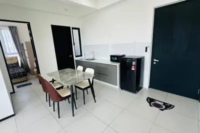 a kitchen with a table and chairs and a refrigerator at Deluxe Seaview Georgetown Penang @ ComfyLux Homestay in Jelutong
