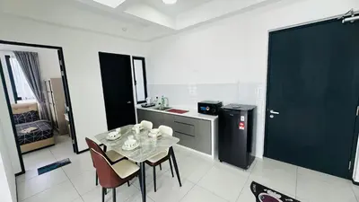 a kitchen with a table and chairs in a room at Deluxe Seaview Georgetown Penang @ ComfyLux Homestay in Jelutong