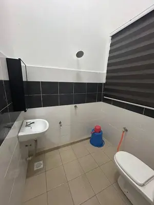 a bathroom with a white toilet and a sink at Homestay De' Afraa Sungai Besar IslamFriendly in Sungai Besar