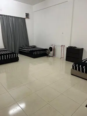a room with two beds and a tiled floor at Homestay De' Afraa Sungai Besar IslamFriendly in Sungai Besar