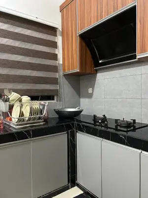 a kitchen with a counter top with dishes on it at Homestay De' Afraa Sungai Besar IslamFriendly in Sungai Besar