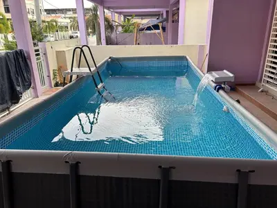 a plunge pool with a fountain in a building at Homestay De' Afraa Sungai Besar IslamFriendly in Sungai Besar