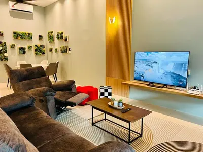 a living room with couches and a flat screen tv at Sunway Ipoh - DamaiStay - 5min to Tambun - 20Pax in Tambun