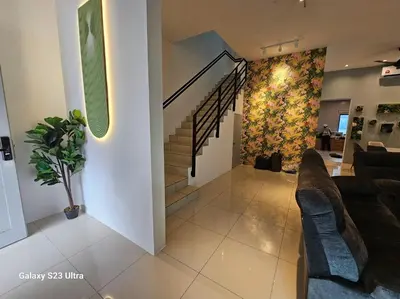 a living room with couches and a staircase in a house at Sunway Ipoh - DamaiStay - 5min to Tambun - 20Pax in Tambun