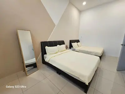 two beds in a small room with a mirror at Sunway Ipoh - DamaiStay - 5min to Tambun - 20Pax in Tambun