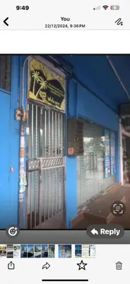 a blue building with a gate on the side of it at BOTANI LOFT HOMESTAY in Ipoh