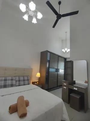 a bedroom with a bed and a ceiling fan at Ipoh Tambun Sunway next to Heaven Spacious Luxury Home in Kampong Batu Lapan