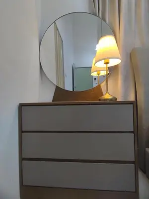 a lamp sitting on a dresser with a mirror at Ipoh Tambun Sunway next to Heaven Spacious Luxury Home in Kampong Batu Lapan