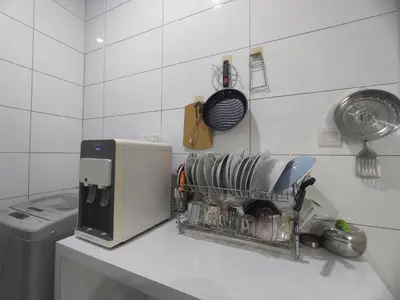 a kitchen counter with a drying rack next to a sink at Ipoh Tambun Sunway next to Heaven Spacious Luxury Home in Kampong Batu Lapan