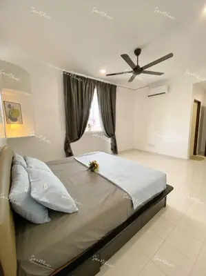 a bedroom with a bed with a ceiling fan at SmartChoice Homestay in Bukit Mertajam