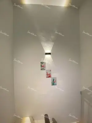 a room with a white wall with pictures on it at SmartChoice Homestay in Bukit Mertajam