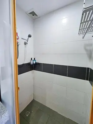 a bathroom with a shower with black and white tiles at The 60 in George Town
