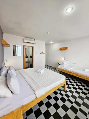 a bedroom with a large bed and a bath tub at The 60 in George Town