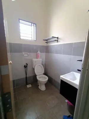 a bathroom with a toilet and a sink at D’Kayangan Homestay BBSAP Sitiawan in Sitiawan