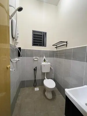 a bathroom with a toilet and a sink at D’Kayangan Homestay BBSAP Sitiawan in Sitiawan