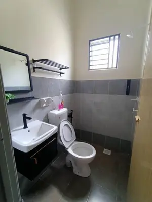 a bathroom with a white toilet and a sink at D’Kayangan Homestay BBSAP Sitiawan in Sitiawan