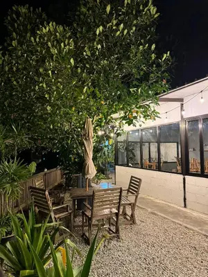 a table and chairs under a tree next to a building at MostPopular!!! Hay Cafe TranquilFields - OnlyYou with Hay, Rentable For Event in Sekincan