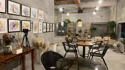a restaurant with tables and chairs and paintings on the wall at MostPopular!!! Hay Cafe TranquilFields - OnlyYou with Hay, Rentable For Event in Sekincan