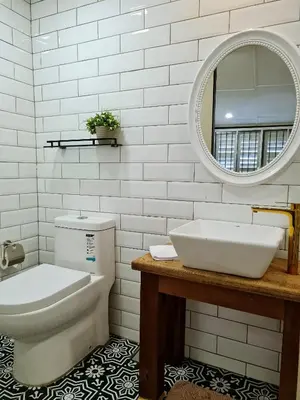 a bathroom with a sink and a toilet and a mirror at Stewart Hotel at 67 By EVR - Newly Renovated 2024 in George Town