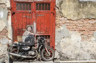 a motorcycle parked in front of a red door at Stewart Hotel at 67 By EVR - Newly Renovated 2024 in George Town
