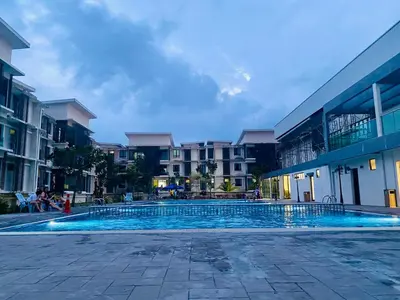 a swimming pool in front of some buildings at Meadow Park (1331 Sweet Home) in Kampong Malim Nawar