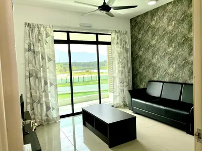 a living room with a black couch and a window at Meadow Park (1331 Sweet Home) in Kampong Malim Nawar