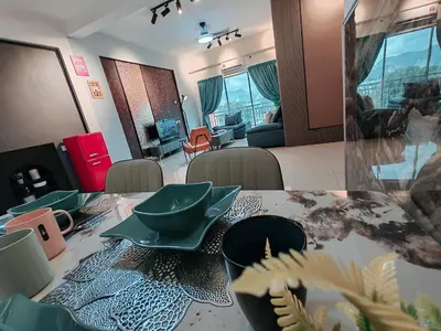 a dining room table with dishes on top of it at INS Pavillion by irainbow in Ipoh