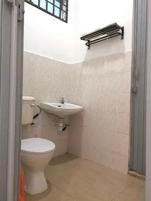 a bathroom with a toilet and a sink at White House 19 Room A in Bukit Mertajam
