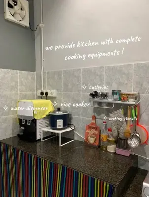 a kitchen with a counter top with words on the wall at Homestay Fida in Gerik