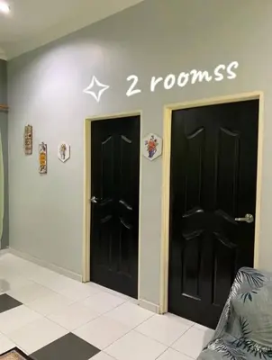 two black doors in a room with a star on the wall at Homestay Fida in Gerik