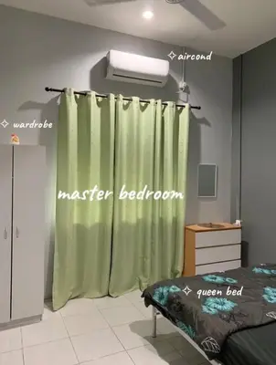 a bedroom with a green shower curtain and a bed at Homestay Fida in Gerik